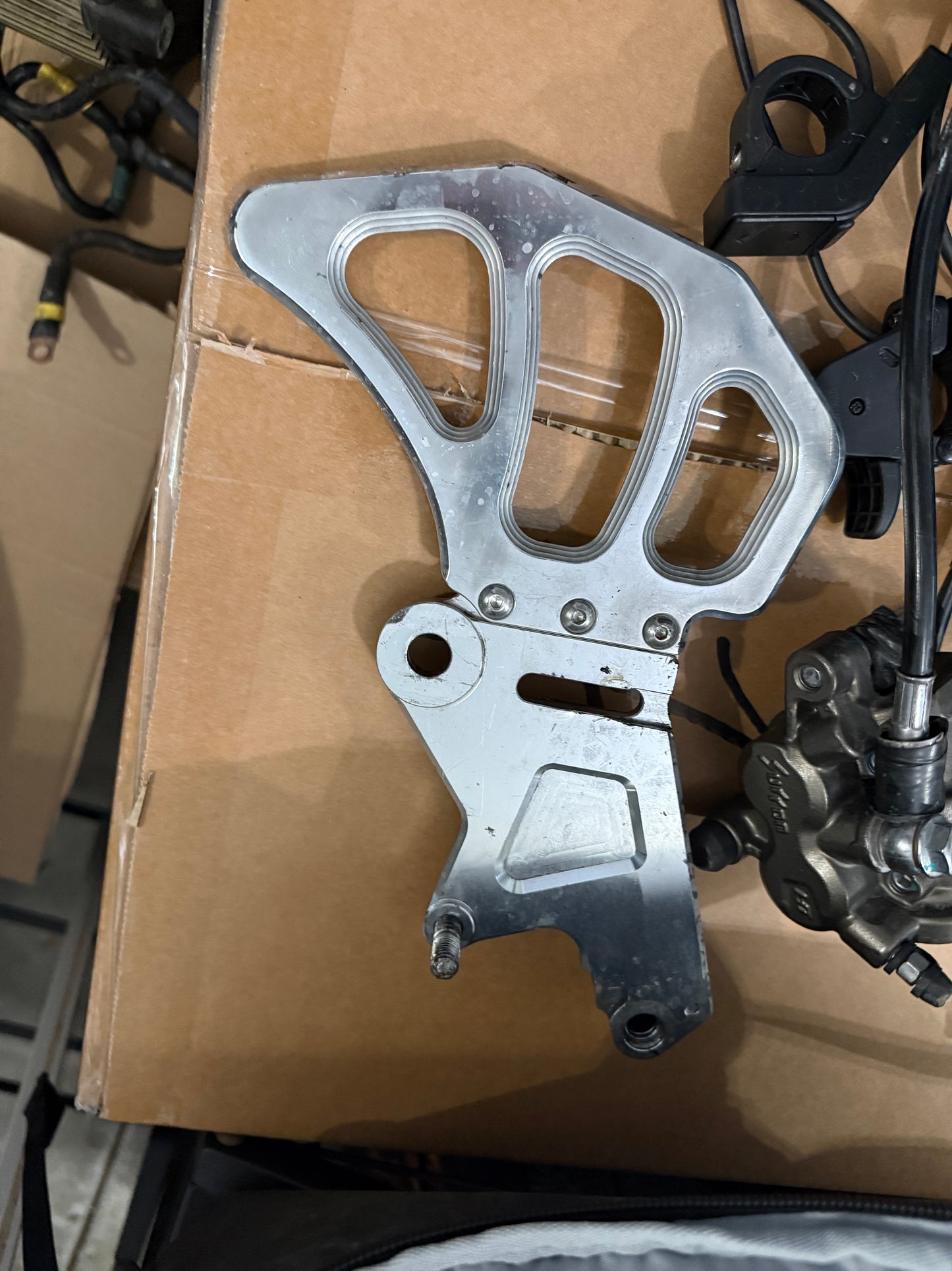 polished surron ultra brake bracket